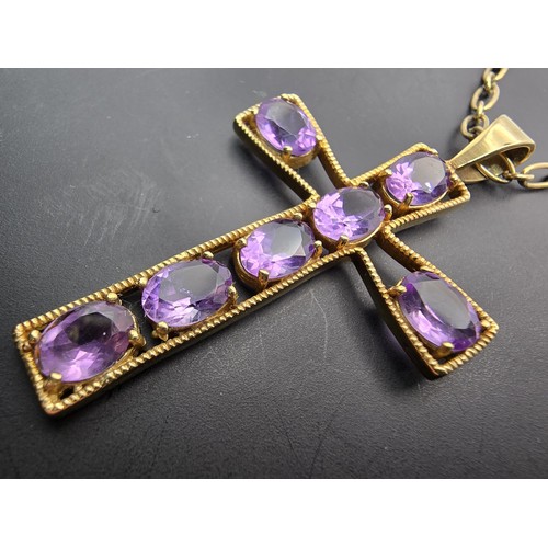 257 - A very pretty hallmarked 9ct yellow gold Cross pendant inset with 7 large faceted amethyst gemstones... 