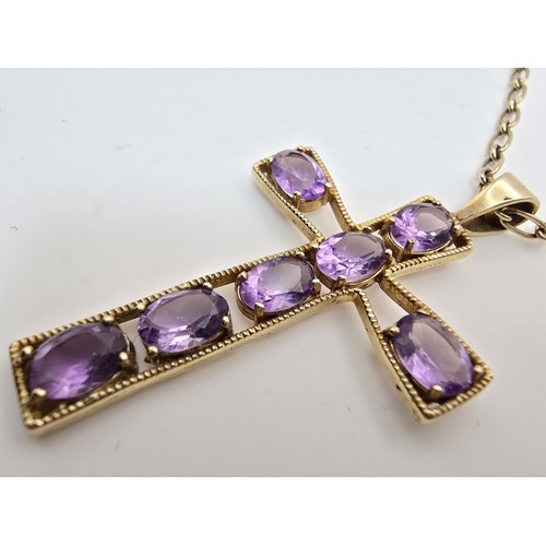 257 - A very pretty hallmarked 9ct yellow gold Cross pendant inset with 7 large faceted amethyst gemstones... 