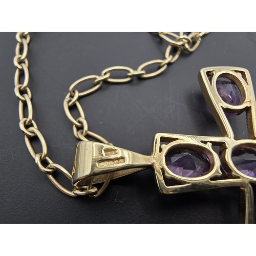 257 - A very pretty hallmarked 9ct yellow gold Cross pendant inset with 7 large faceted amethyst gemstones... 