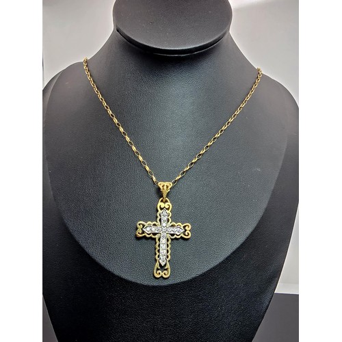 258 - An ornate pretty hallmarked 9ct yellow old Cross pendant inset with a quantity of sparkly crystal st... 