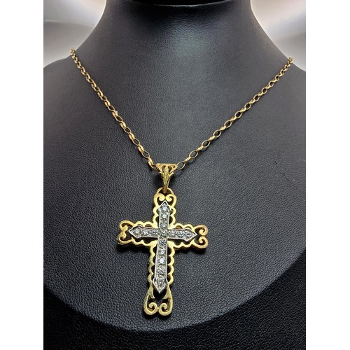 258 - An ornate pretty hallmarked 9ct yellow old Cross pendant inset with a quantity of sparkly crystal st... 