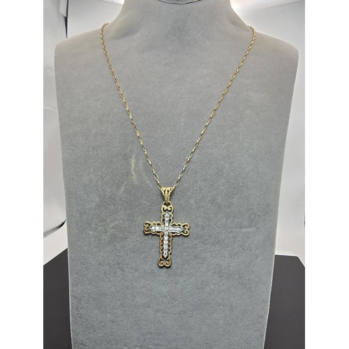 258 - An ornate pretty hallmarked 9ct yellow old Cross pendant inset with a quantity of sparkly crystal st... 