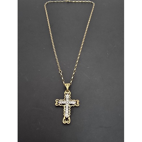 258 - An ornate pretty hallmarked 9ct yellow old Cross pendant inset with a quantity of sparkly crystal st... 