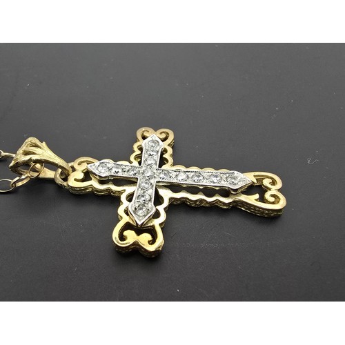 258 - An ornate pretty hallmarked 9ct yellow old Cross pendant inset with a quantity of sparkly crystal st... 