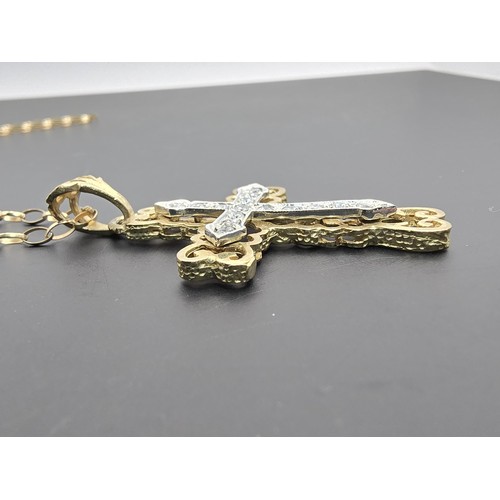 258 - An ornate pretty hallmarked 9ct yellow old Cross pendant inset with a quantity of sparkly crystal st... 