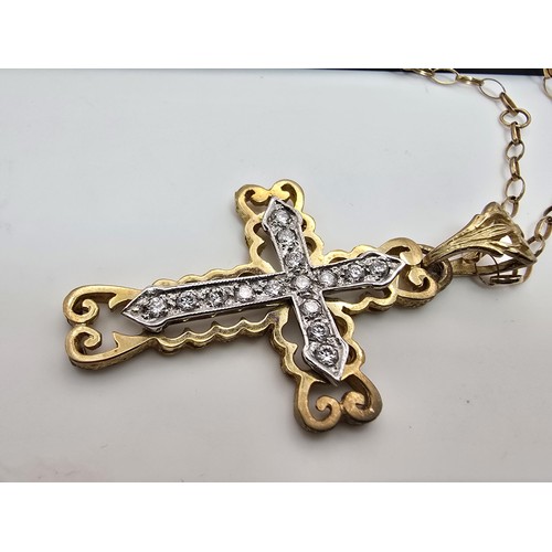 258 - An ornate pretty hallmarked 9ct yellow old Cross pendant inset with a quantity of sparkly crystal st... 