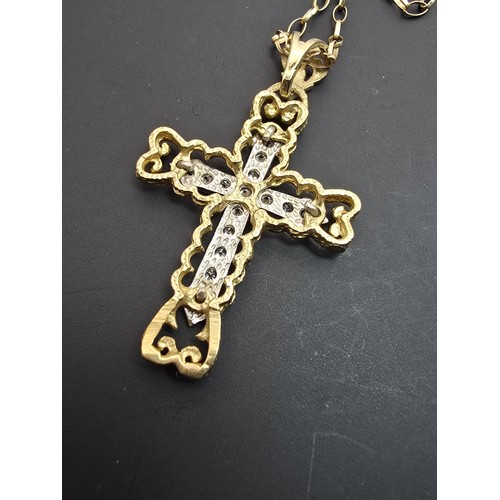 258 - An ornate pretty hallmarked 9ct yellow old Cross pendant inset with a quantity of sparkly crystal st... 