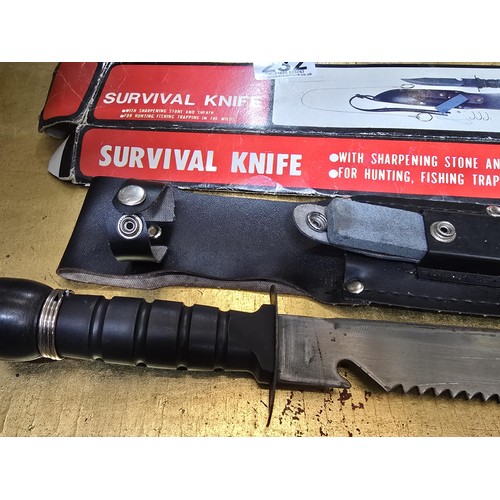 232 - A boxed survival knife with sharpening stone and sheath featuring a compass to the end, it would hav... 