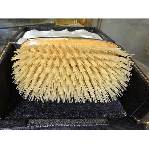 235 - A good quality hallmarked silver backed grooming brush fitted in its original case, the silver brush... 