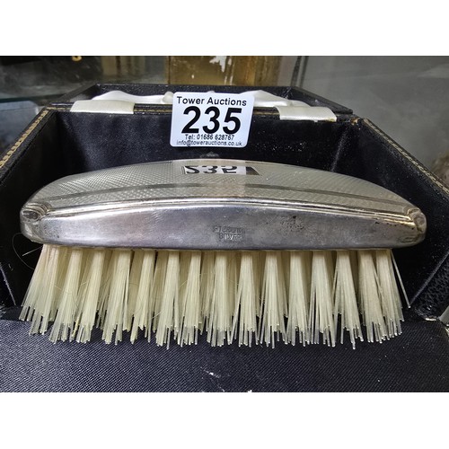 235 - A good quality hallmarked silver backed grooming brush fitted in its original case, the silver brush... 