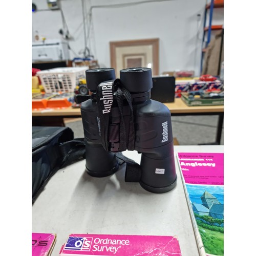 91 - A cased pair of binoculars, Bushnell 10-30x50 and complete with instructions along with a small quan... 