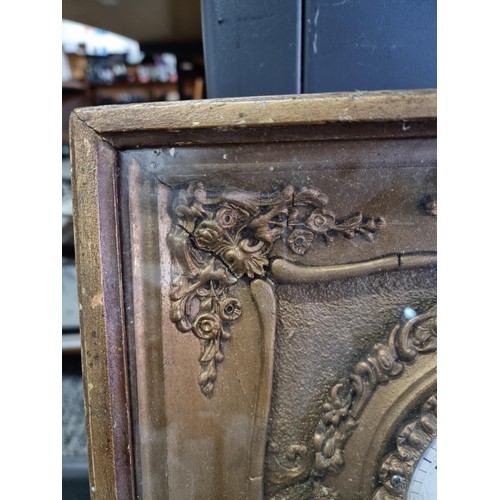 100 - Antique picture frame gilt french clock with floral decoration to the frame in need of restoration c... 