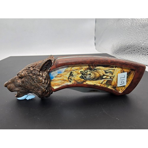 244 - A good ornate novelty penknife by Franklin Mint with a wolf picture scene to the handle having a cas... 