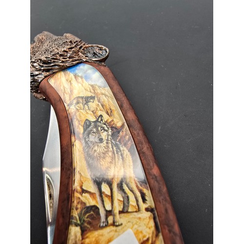 244 - A good ornate novelty penknife by Franklin Mint with a wold picture scene to the handle having a cas... 