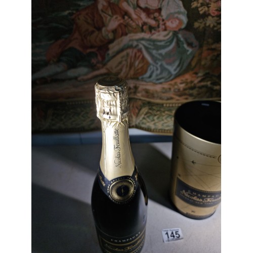 145 - New and sealed bottle of Nicolas Feuillatte Champagne set in a metal champagne bottle with a foam to... 