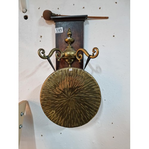 141 - Good quality wall hanging vintage brass dinner gong and hammer on a wooden mount, the gong is decora... 