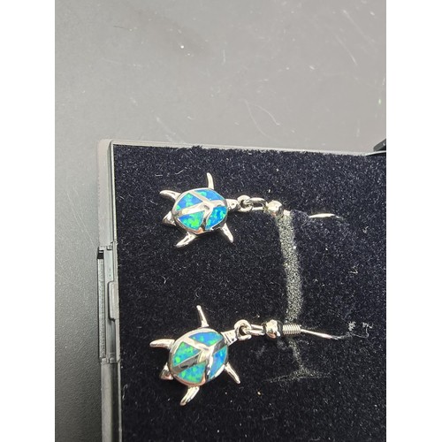 181 - A pair of pretty brand new silver tone earrings in the form of a turtle inset with real opal present... 