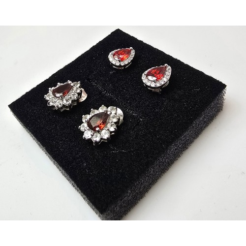 196 - 2 pairs of pretty 925 silver stud earrings, both pairs are inset with garnet gemstones 1 pair surrou... 