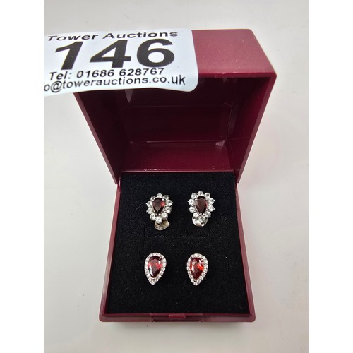 196 - 2 pairs of pretty 925 silver stud earrings, both pairs are inset with garnet gemstones 1 pair surrou... 