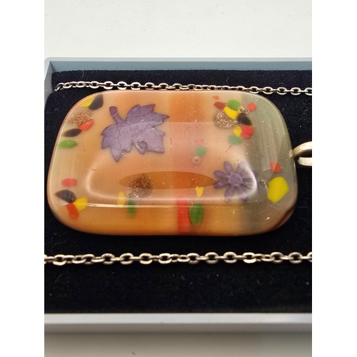 192 - An attractive large art glass pendant with a colourful design set on a 22