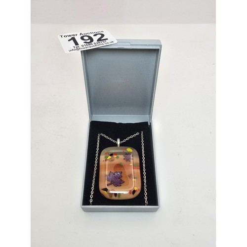 192 - An attractive large art glass pendant with a colourful design set on a 22