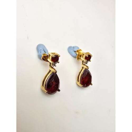 262 - A pair of pretty 10ct yellow gold drop earrings inset with stunning almandine garnet faceted gemston... 