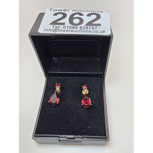 262 - A pair of pretty 10ct yellow gold drop earrings inset with stunning almandine garnet faceted gemston... 