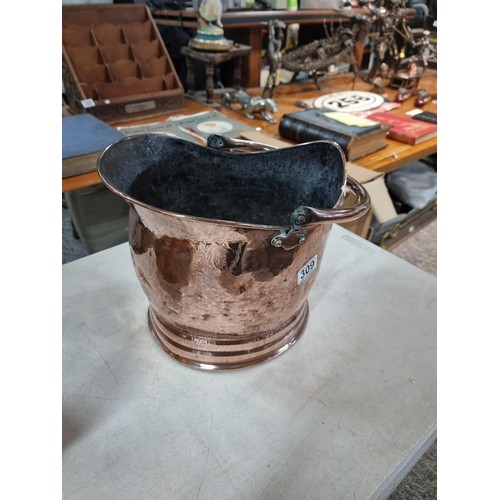 309 - Good quality copper coal scuttle with hammered decoration along with a large brass planter style log... 