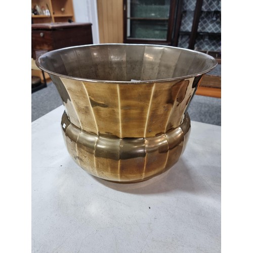 309 - Good quality copper coal scuttle with hammered decoration along with a large brass planter style log... 