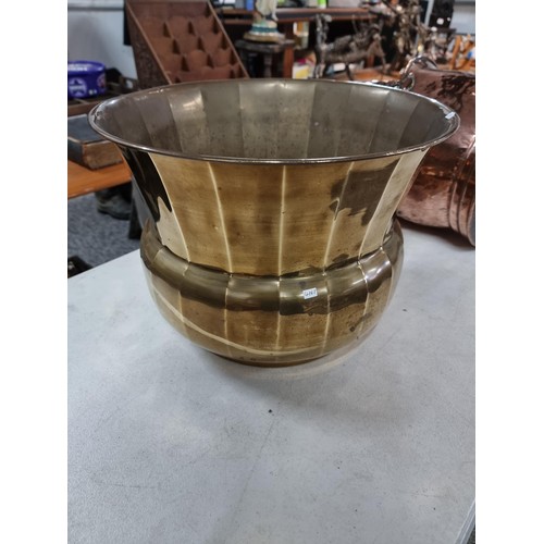 309 - Good quality copper coal scuttle with hammered decoration along with a large brass planter style log... 