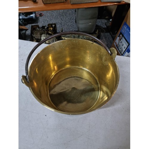 312 - Large brass jam pan in good order with cast iron handle measures 17cm high 36cm diameter