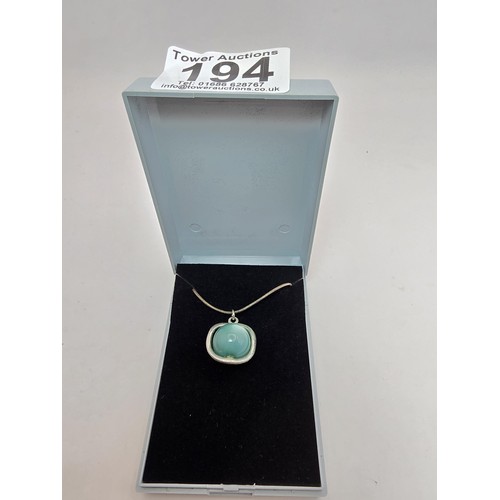 215 - An unusual pendant inset with a blue Beryl cats eye stone in the form of a ball on an 18