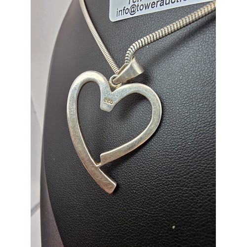 217 - A large 925 silver heart pendant inset with sparkly CZ stones, set on a good quality chunky 18