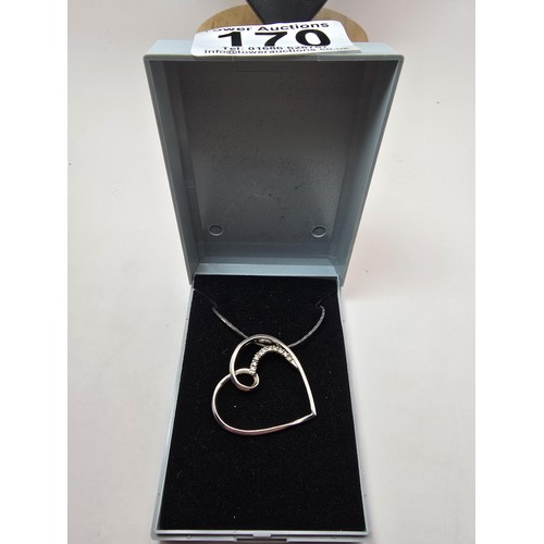 218 - A large 925 silver heart formed pendant inset with sparkly crystal CZ stones on an 18