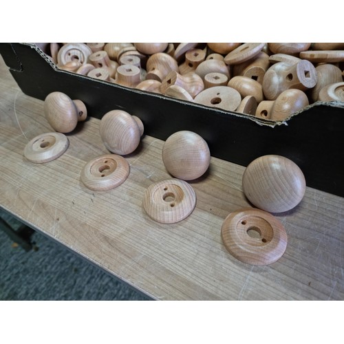 328 - Box containing a large quantity of smooth wooden door knobs, all have a 9mm square hole in them.