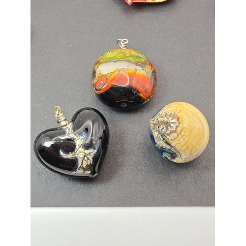 226 - A large bundle of good quality art glass pendants, all with very interesting designs,  some are made... 