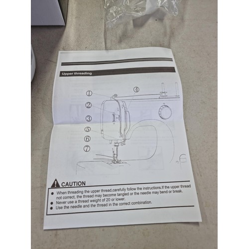 385 - Boxed Mini sewing machine in good order has 10 memory settings for stitch patterns, comes with a sma... 