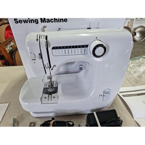 385 - Boxed Mini sewing machine in good order has 10 memory settings for stitch patterns, comes with a sma... 