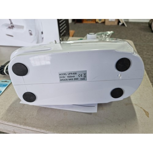 385 - Boxed Mini sewing machine in good order has 10 memory settings for stitch patterns, comes with a sma... 