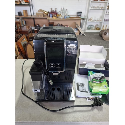 391 - A Delonghi Dinamica Plus coffee machine in good order, includes operation manual and a sealed bag of... 