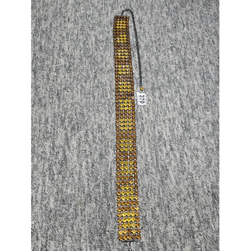 270 - An impressive vintage ladies costume belt which has 5 rows of amber coloured rhinestones, the belt i... 