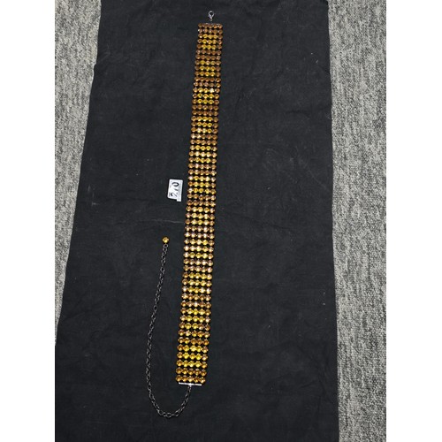 270 - An impressive vintage ladies costume belt which has 5 rows of amber coloured rhinestones, the belt i... 