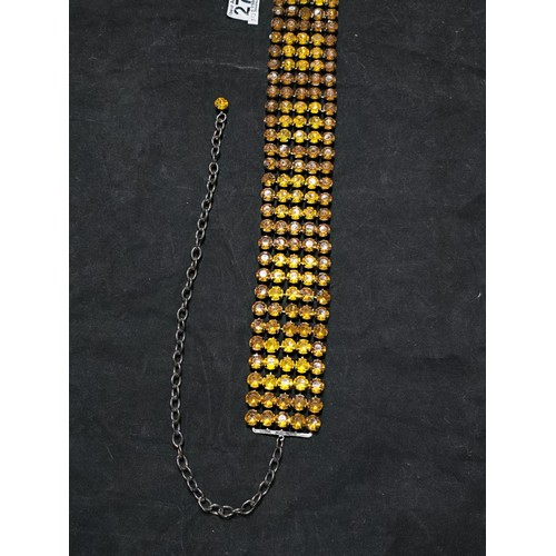 270 - An impressive vintage ladies costume belt which has 5 rows of amber coloured rhinestones, the belt i... 