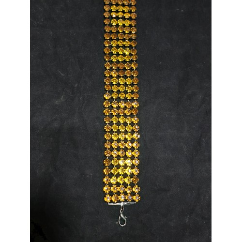 270 - An impressive vintage ladies costume belt which has 5 rows of amber coloured rhinestones, the belt i... 