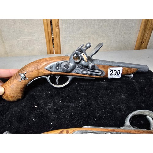 290 - A pair of replica 18th century pirates flintlock pistols made out of solid wood with a zinc metal ba... 