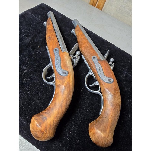 290 - A pair of replica 18th century pirates flintlock pistols made out of solid wood with a zinc metal ba... 