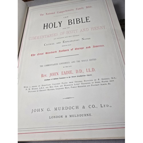 294 - A large antique family holy bible with a black leather hard cover featuring gilt and ornate corners ... 