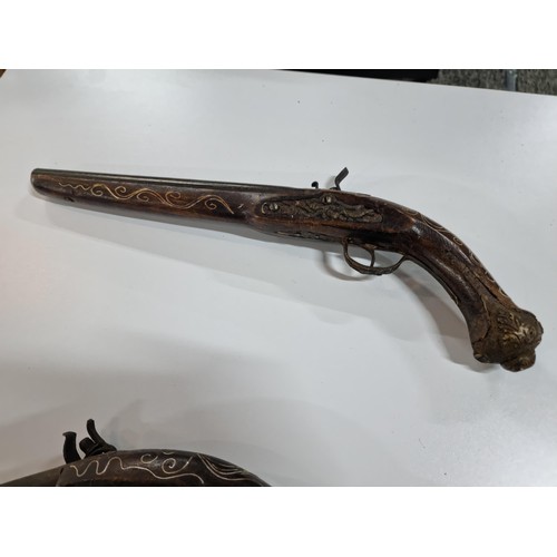 302 - Pair of replica 18th century flint lock, the pistols are made from wood with an iron barrel and hamm... 