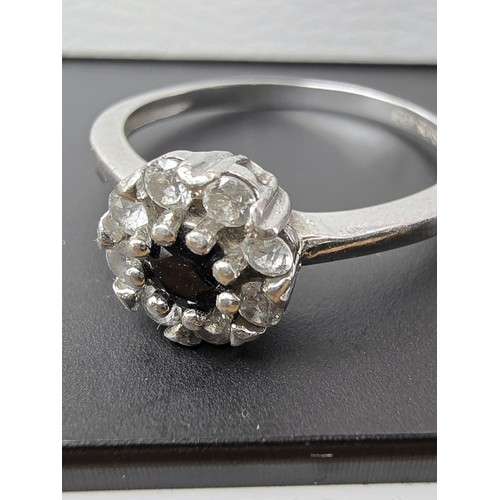 225 - A pretty as new 925 silver cluster ring inset with very sparkly clear CZ crystal stones with a black... 