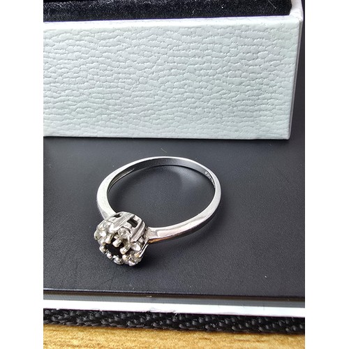 225 - A pretty as new 925 silver cluster ring inset with very sparkly clear CZ crystal stones with a black... 